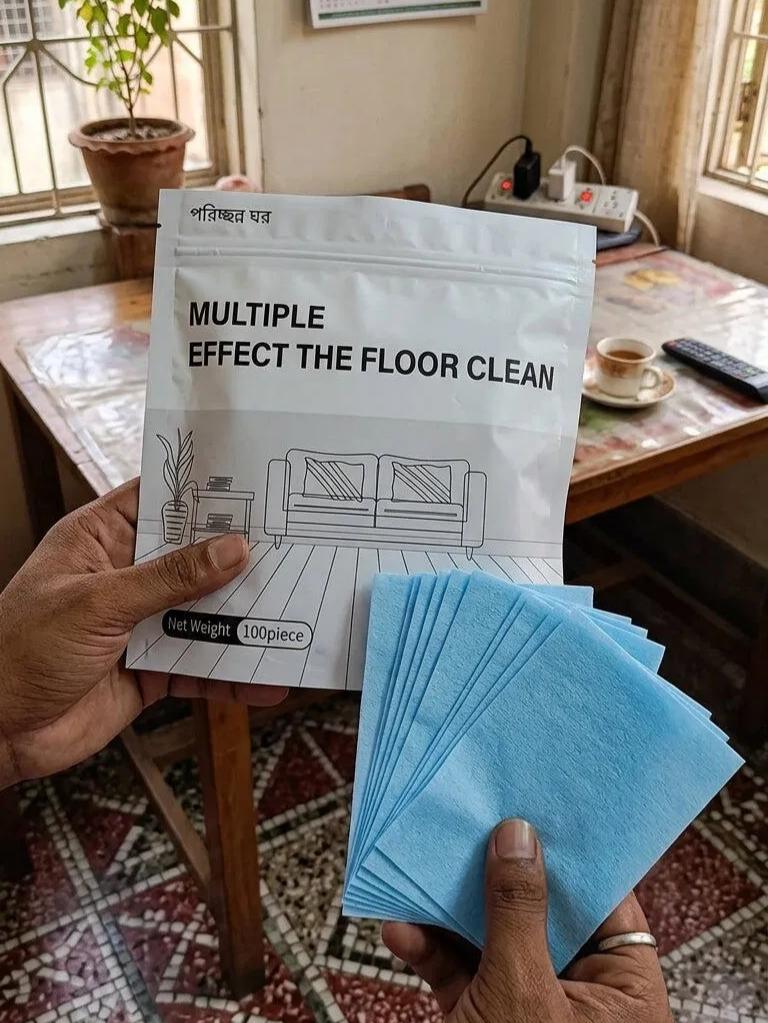 Customer holding the floor cleaning product and blue cleaning sheets